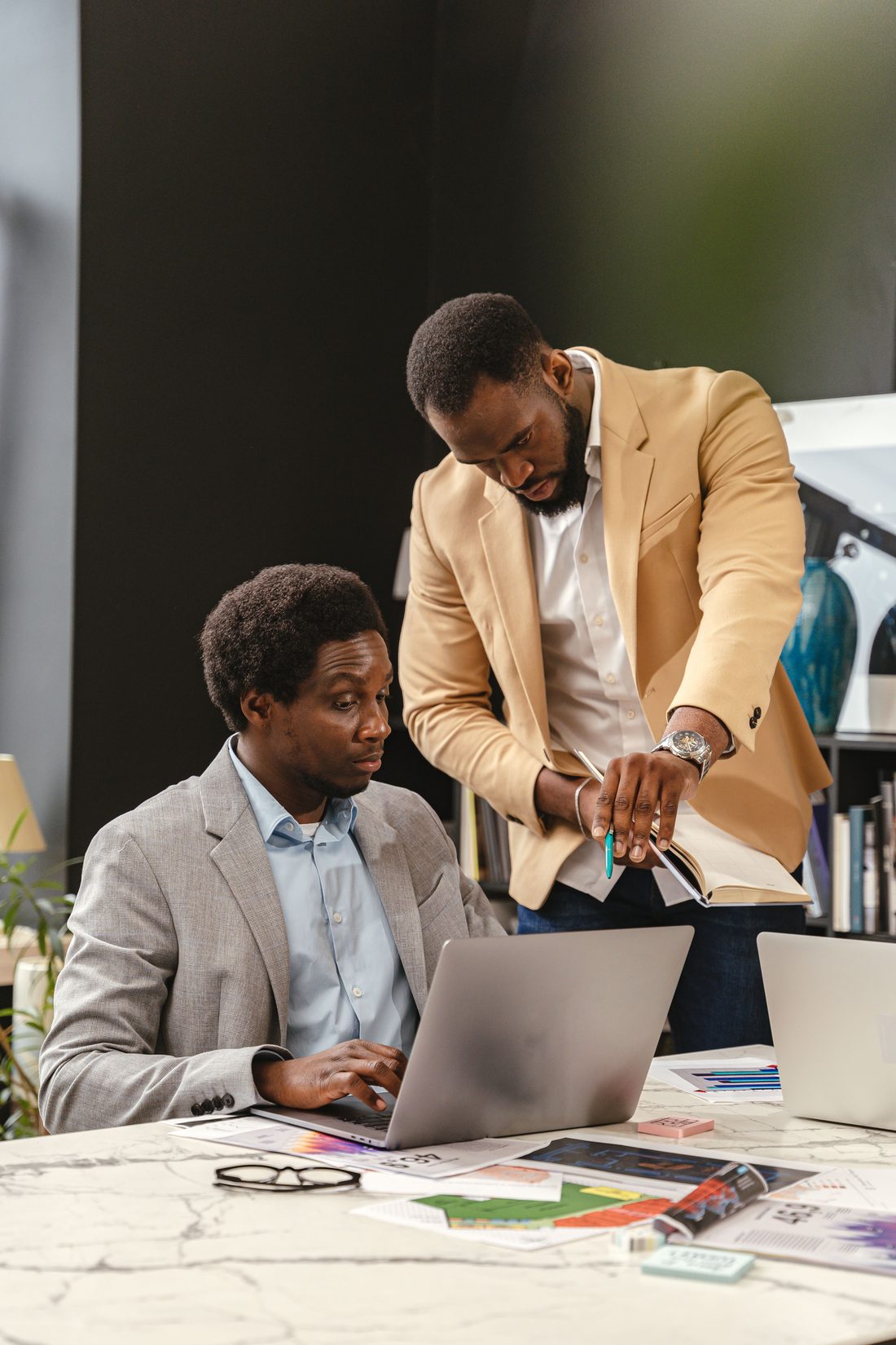 Two colleagues reviewing a role evaluation together at a laptop